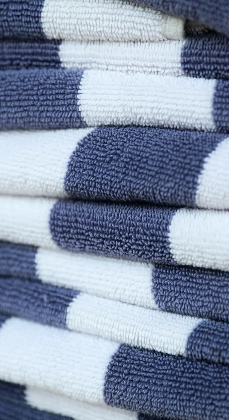 A neat stack of navy and white striped towels