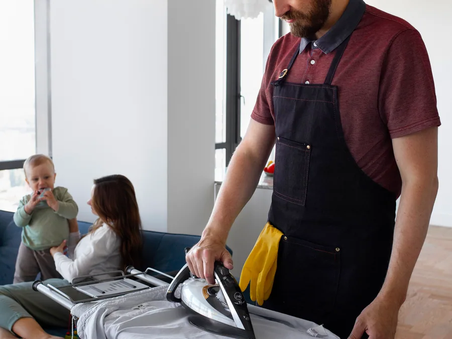 A shirt being pressed on an ironing board
